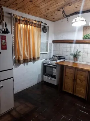 a kitchen with a stove and a refrigerator at La Rustica in El Durazno