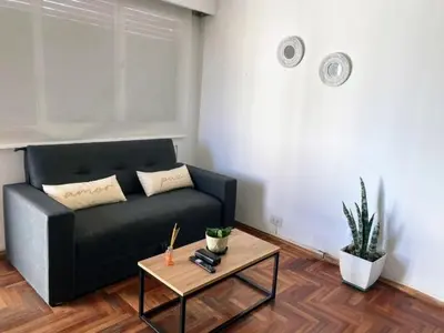 a living room with a black couch and a table at Balcones del Calicanto in Cordoba
