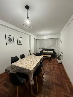 a living room with a table and chairs and a bed at Balcones del Calicanto in Cordoba