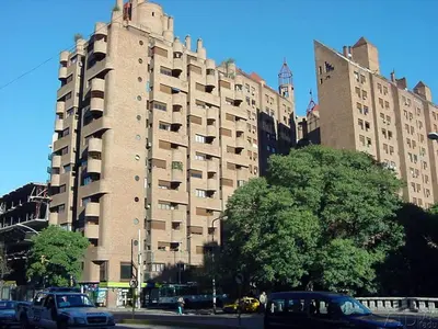 a large building with cars parked in front of it at Balcones del Calicanto in Cordoba