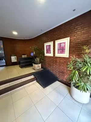 a lobby with potted plants and a brick wall at Balcones del Calicanto in Cordoba