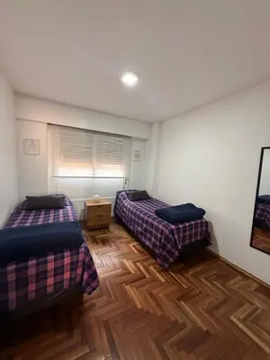 two beds in a room with wooden floors at Balcones del Calicanto in Cordoba