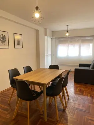 a dining room with a wooden table and chairs at Balcones del Calicanto in Cordoba