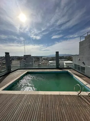 a swimming pool on the roof of a building at Departamento Galeria Strada in Villa Carlos Paz