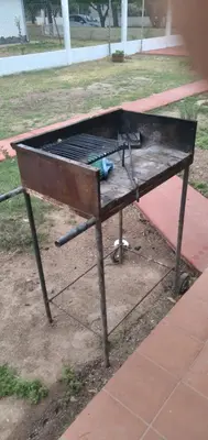 a barbecue grill sitting on the side of a sidewalk at La Colonial Cabañas in Villa Cura Brochero
