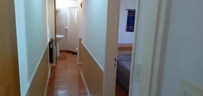 a hallway with a hallway leading to a bathroom at La Colonial Cabañas in Villa Cura Brochero