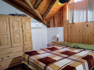 a bedroom with a bed and a wooden ceiling at Casa VD in Santa Rosa de Calamuchita