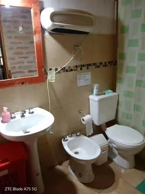 a bathroom with a toilet and a sink at Casa VD in Santa Rosa de Calamuchita