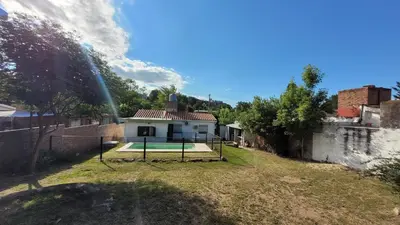 a house with a tennis court in a yard at Casa Cedro Azul II in Villa Carlos Paz