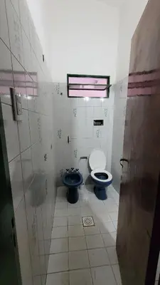 a bathroom with a toilet and a sink in it at Casa Cedro Azul II in Villa Carlos Paz