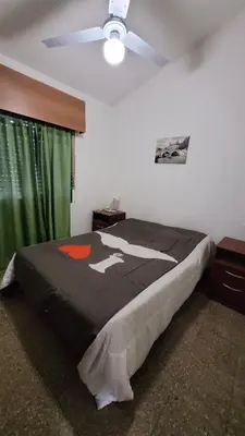 a bedroom with a bed and a ceiling fan at Casa Cedro Azul II in Villa Carlos Paz
