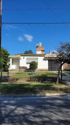 a white house with a fence in front of it at Casa Cedro Azul II in Villa Carlos Paz