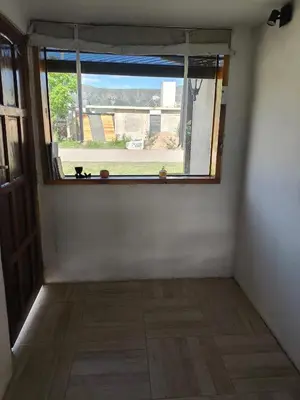 an empty room with a window and a wooden floor at Las Carolas in Santa María