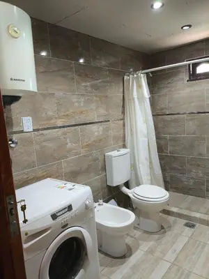 a bathroom with a toilet and a washing machine at Las Carolas in Santa María