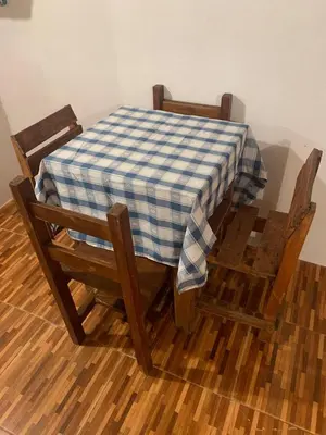 a table and two chairs with a checkered table cloth on it at Monarcas III in Villa Carlos Paz