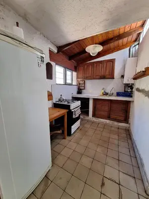 a kitchen with a stove and a refrigerator in it at CASA EN VILLA LA BOLSA, Córdoba in Cordoba