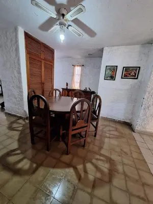 a dining room with a table and chairs at CASA EN VILLA LA BOLSA, Córdoba in Cordoba