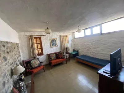 a living room with a couch and chairs and a tv at CASA EN VILLA LA BOLSA, Córdoba in Cordoba