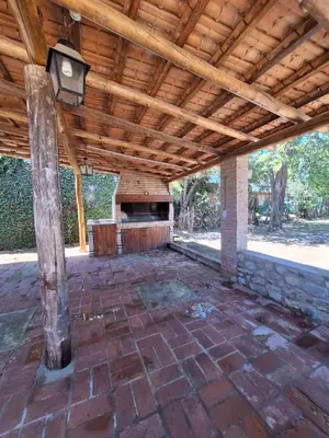an outdoor patio with a wooden ceiling and a stone floor at CASA EN VILLA LA BOLSA, Córdoba in Cordoba