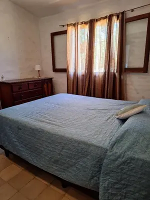 a bedroom with a large bed and a window at CASA EN VILLA LA BOLSA, Córdoba in Cordoba