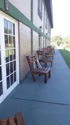 a row of benches sitting outside of a building at Estancia la aguada in Embalse