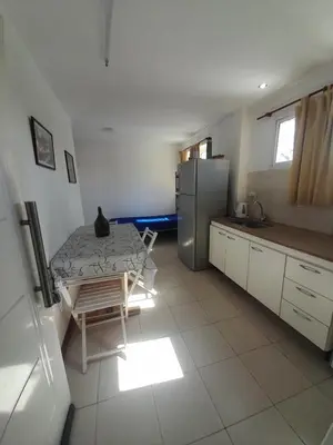 a kitchen with a table and a refrigerator at Los gigantes posada in Villa Carlos Paz