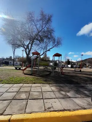 a park with a playground with two swings at Los gigantes posada in Villa Carlos Paz