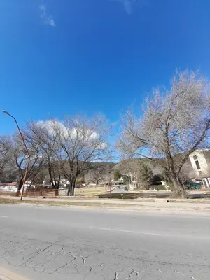 an empty street with trees on the side of the road at Los gigantes posada in Villa Carlos Paz