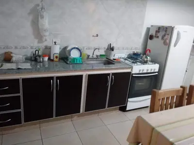 a kitchen with a sink and a stove and a refrigerator at Olga Carlos paz in Villa Carlos Paz