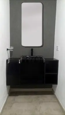 a black desk with a white monitor on a wall at Departamento zona estadio Kempes in Cordoba