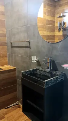 a bathroom with a black sink and a mirror at Departamento zona estadio Kempes in Cordoba