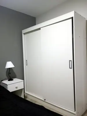 a large white sliding door in a bedroom at Departamento zona estadio Kempes in Cordoba