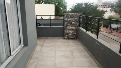 a balcony with a stone wall next to a window at Departamento zona estadio Kempes in Cordoba