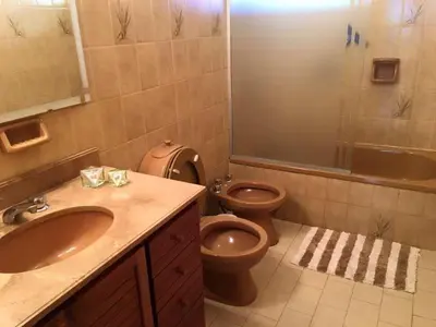 a bathroom with a toilet and a sink and a shower at Casa alquiler Villa Carlos Paz in Villa Carlos Paz