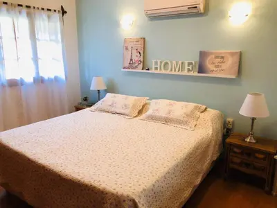 a bedroom with a bed and a window at Casa alquiler Villa Carlos Paz in Villa Carlos Paz