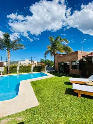 a swimming pool in the yard of a house at Casa alquiler Villa Carlos Paz in Villa Carlos Paz