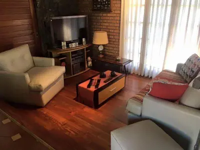 a living room with two couches and a tv at Casa alquiler Villa Carlos Paz in Villa Carlos Paz