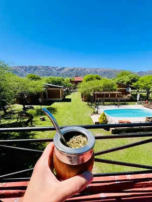 a person holding a cup of food with a spoon at Cabañas Los Tinos in Carpintería