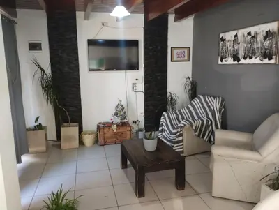 a living room with a tv on a wall at Sin nombre in Mina Clavero