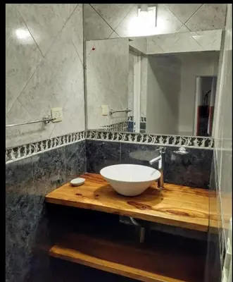 a bathroom with a sink and a mirror at Sin nombre in Mina Clavero