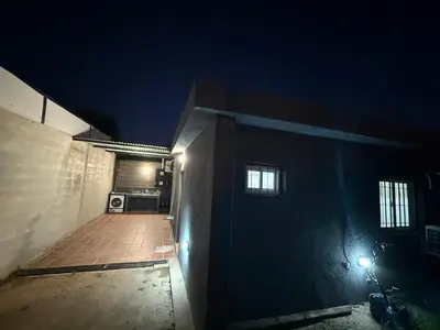 a dark room with a kitchen in a house at night at house with garage in Cordoba