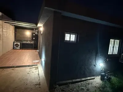 a dark room with a door and a kitchen at house with garage in Cordoba