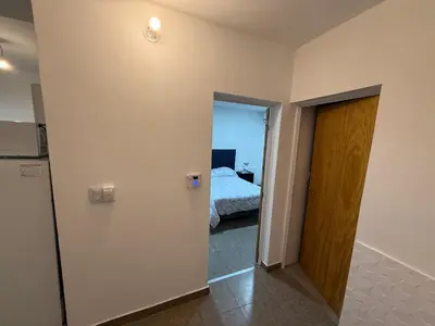 a room with a door leading to a bedroom at house with garage in Cordoba
