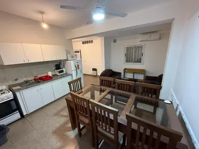 a kitchen and dining room with a table and chairs at house with garage in Cordoba