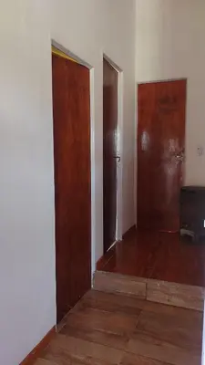 an empty room with two doors and wooden floors at canchu 11 in Arroyo de Los Patos