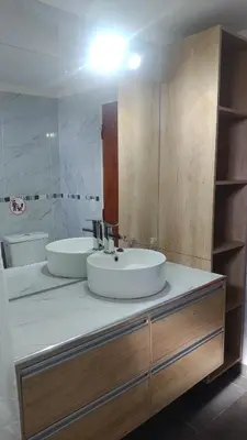 a bathroom with two sinks and a large mirror at canchu 11 in Arroyo de Los Patos