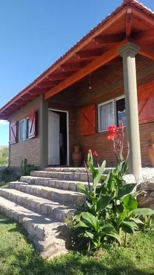 a brick house with stairs leading to a door at canchu 11 in Arroyo de Los Patos