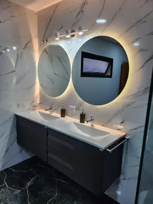 a bathroom with two sinks and two mirrors at Hotel El Paraiso Boutique in Villa Carlos Paz