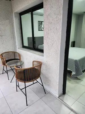 a room with two chairs and a table and a bed at Hotel El Paraiso Boutique in Villa Carlos Paz