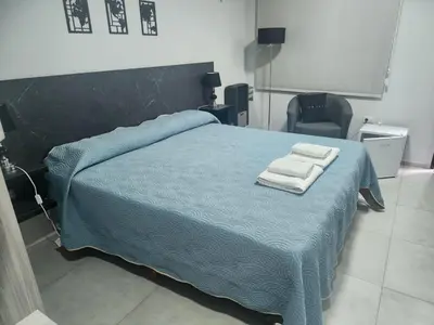 a bedroom with a bed with two towels on it at Hotel El Paraiso Boutique in Villa Carlos Paz